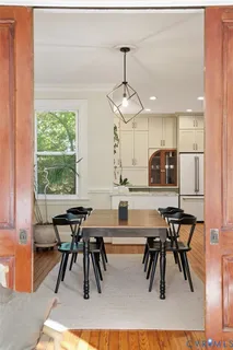 a view of a dining room with furniture window and wooden floor