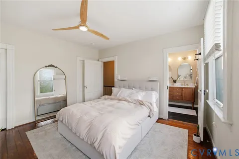 a bedroom with a bed and a mirror