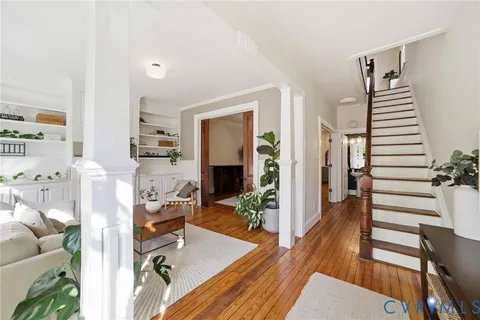 a living room with furniture and wooden floor