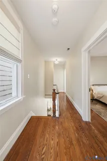 a view of a room with wooden floor and a window