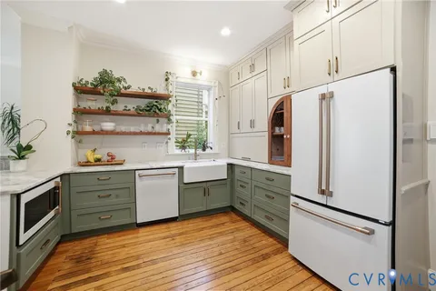 a kitchen with stainless steel appliances a refrigerator sink and cabinets