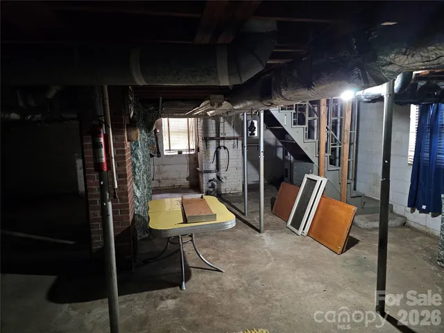 a view of a house with a yard and large trees