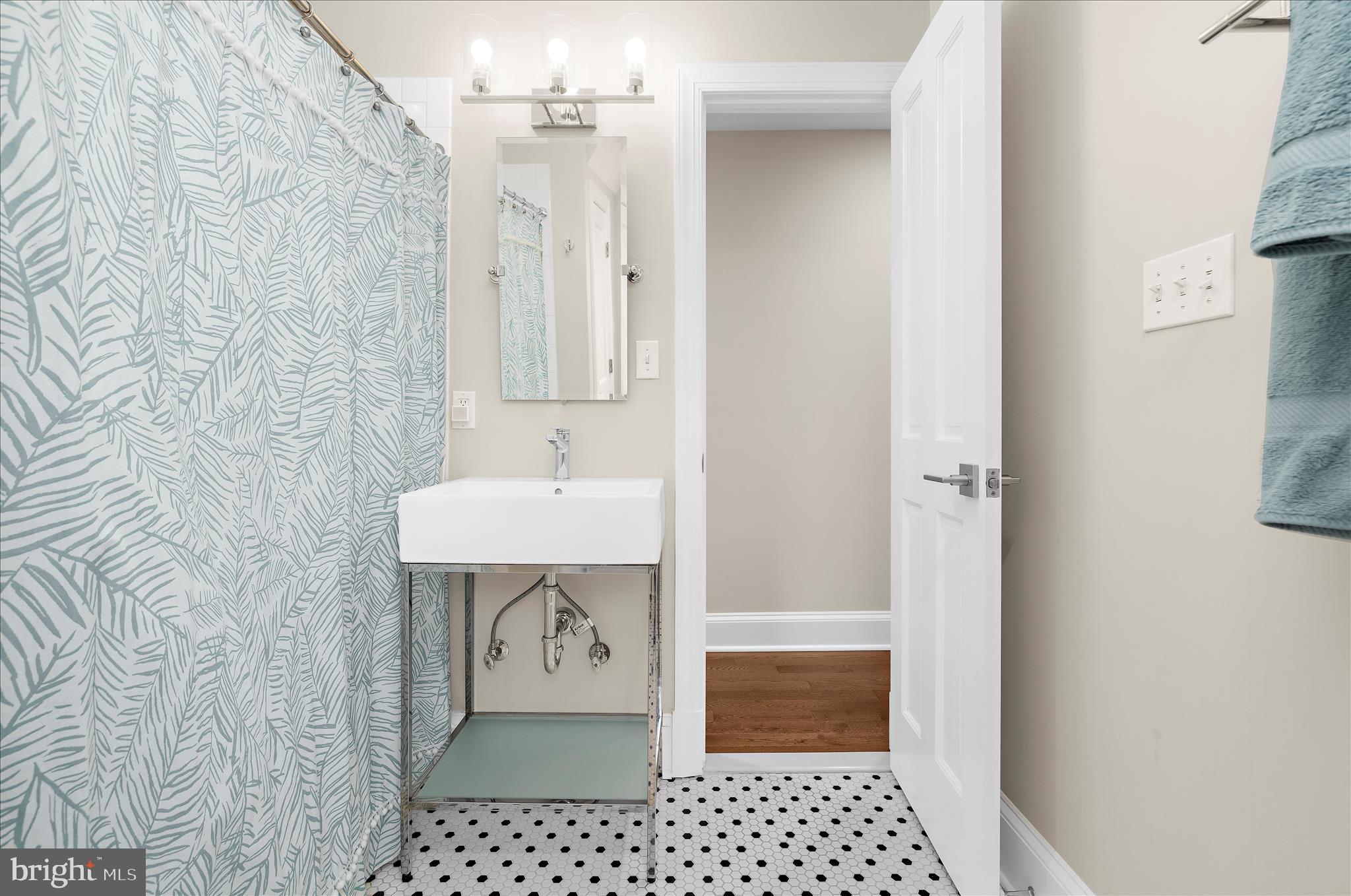 1102 Poplar Avenue Annapolis, MD 21401 - Photo 27 of 125 a bathroom with a sink a toilet and shower