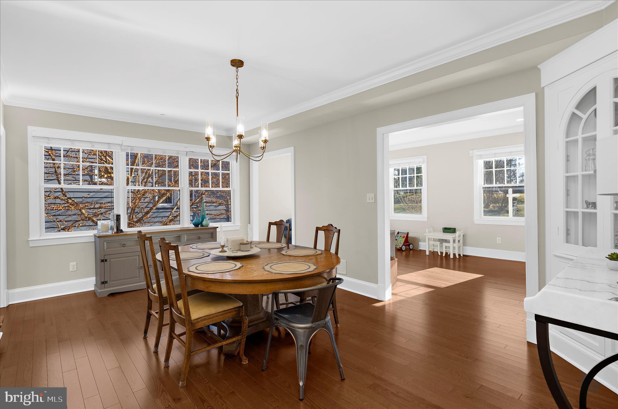 1102 Poplar Avenue Annapolis, MD 21401 - Photo 10 of 125 a dining room with wooden floor a chandelier a wooden table and chairs