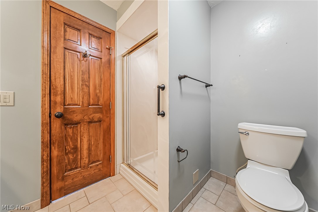 28575 Cannon Road Solon, OH 44139 - Photo 22 of 36 Bathroom with tile flooring, toilet, and a shower with door