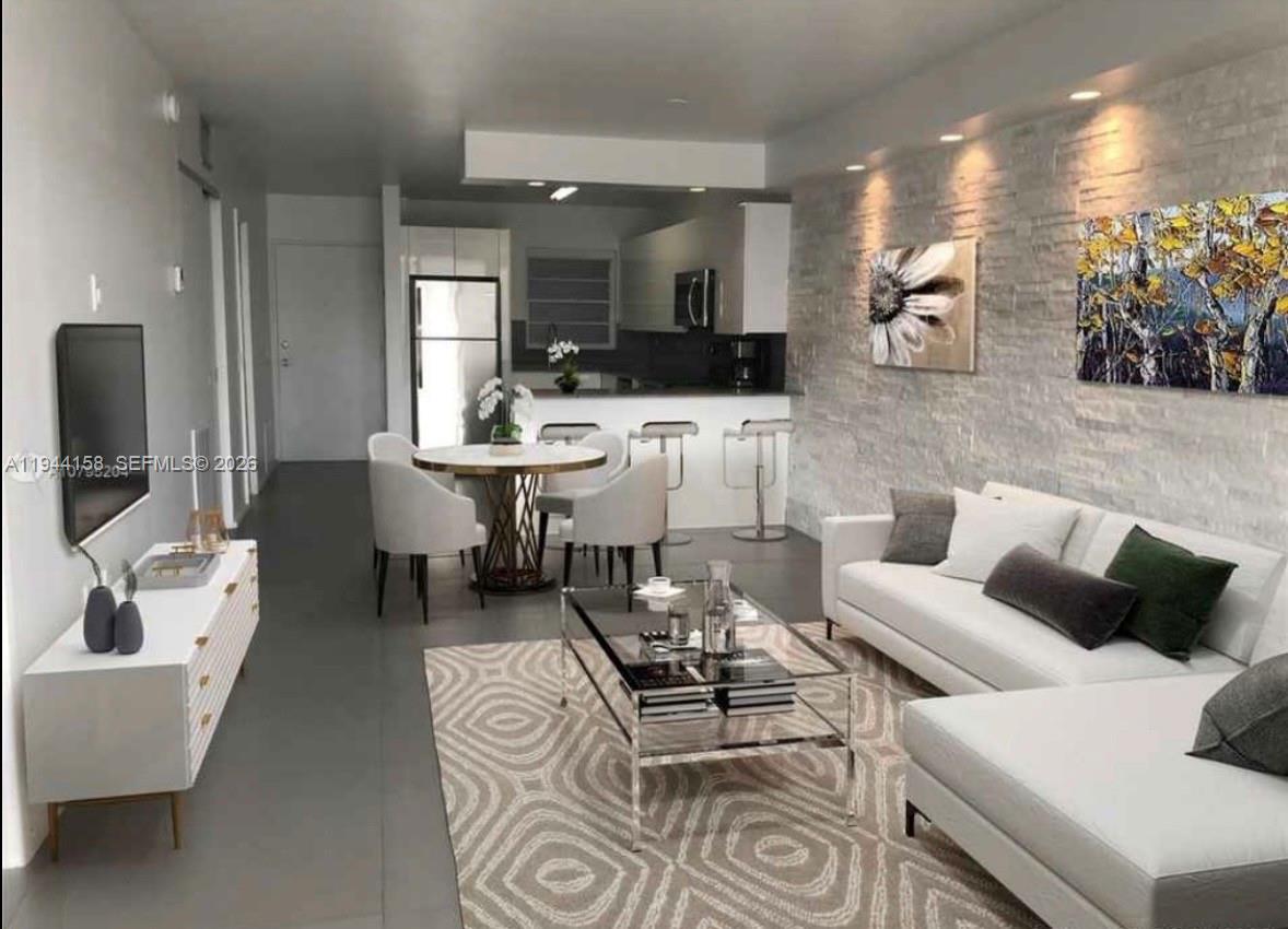 1331 Lincoln Road, Unit 1004 Miami Beach, FL 33139 - Photo 1 of 9 a living room with furniture and a flat screen tv