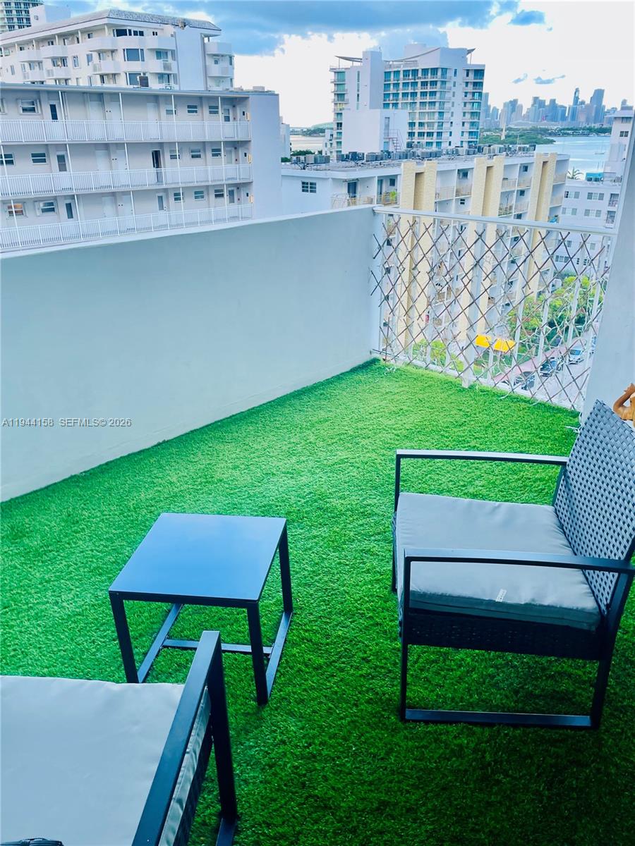 1331 Lincoln Road, Unit 1004 Miami Beach, FL 33139 - Photo 3 of 9 a view of a chairs and table in the yard