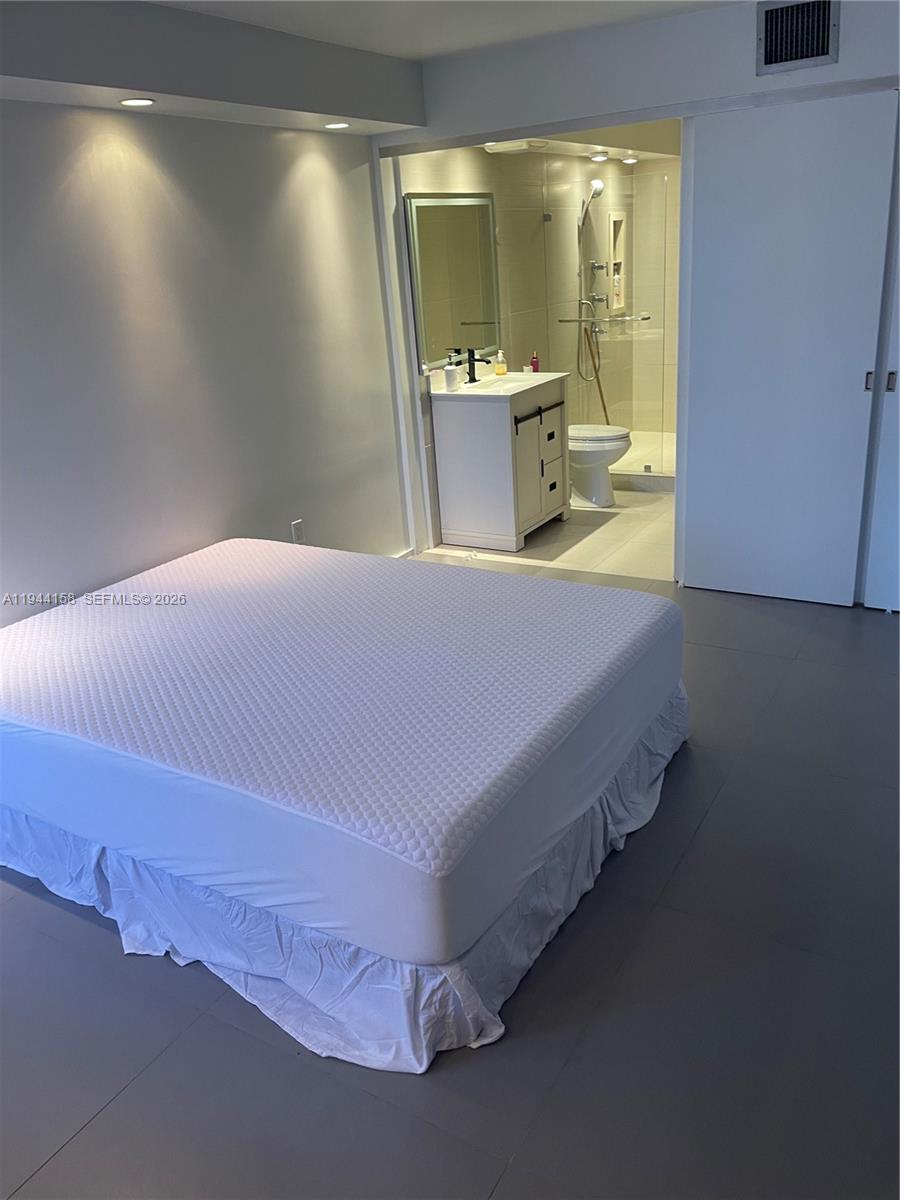 1331 Lincoln Road, Unit 1004 Miami Beach, FL 33139 - Photo 4 of 9 a bedroom with a bed and window