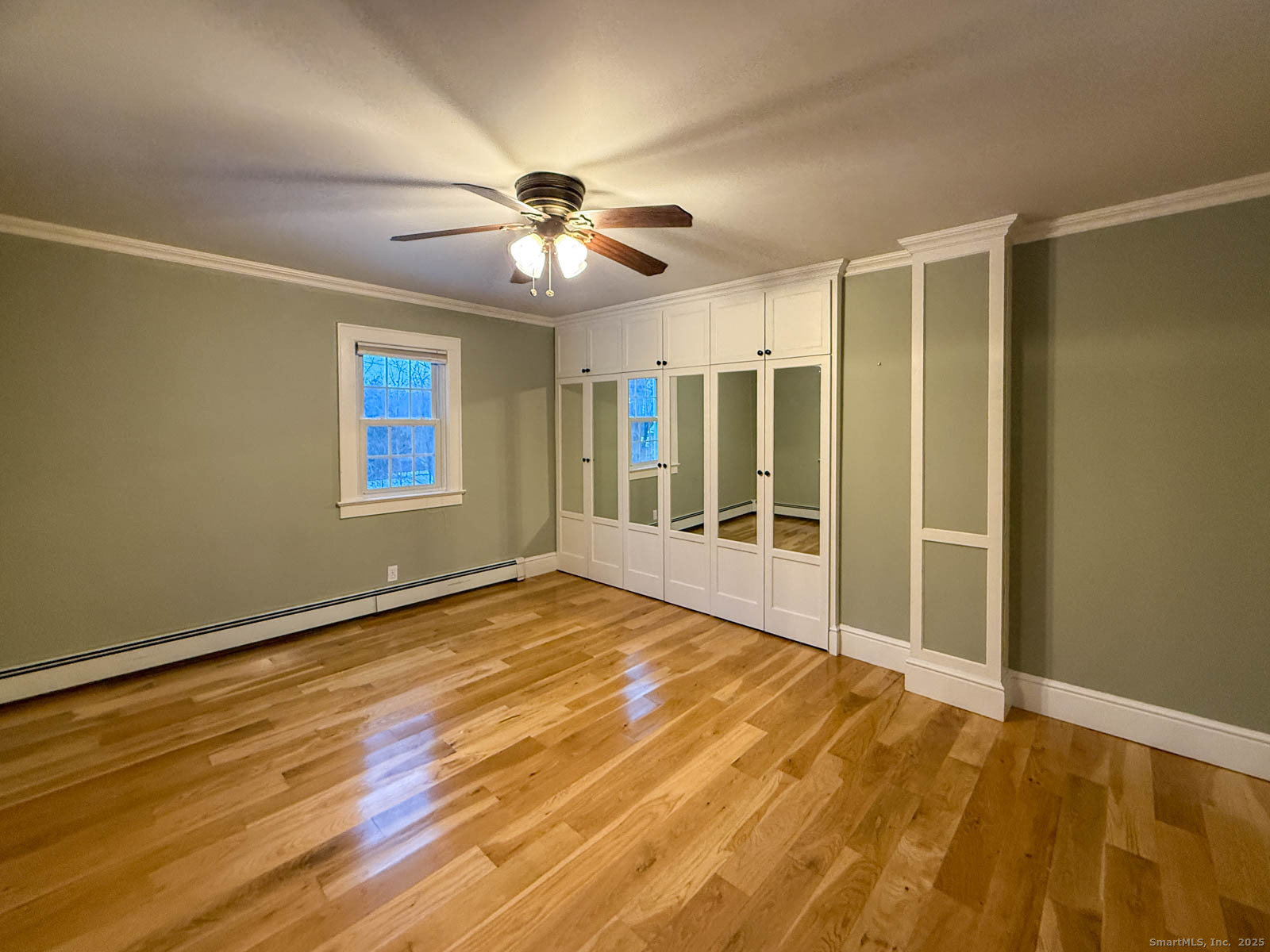 2 Maple Lane New Fairfield, CT 06812 - Photo 13 of 35 a view of an empty room with window and wooden floor