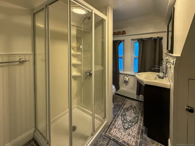 a view of a room with wooden floor and window