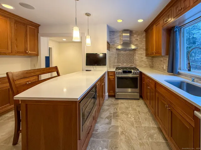 a kitchen with a sink stove and oven
