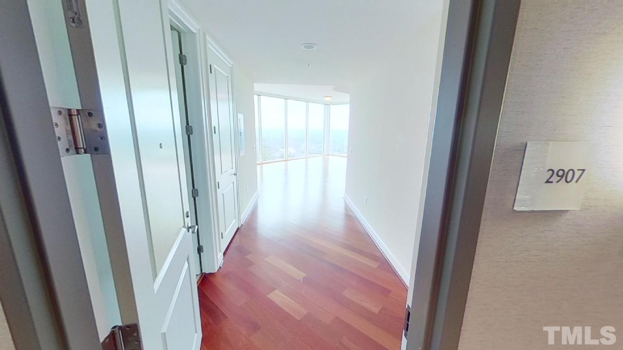 301 Fayetteville Street, Unit 2907 Raleigh, NC 27601 - Photo 3 of 15 a view of a hallway with a wooden floor