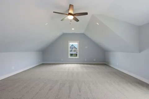 an empty room with a ceiling fan and window