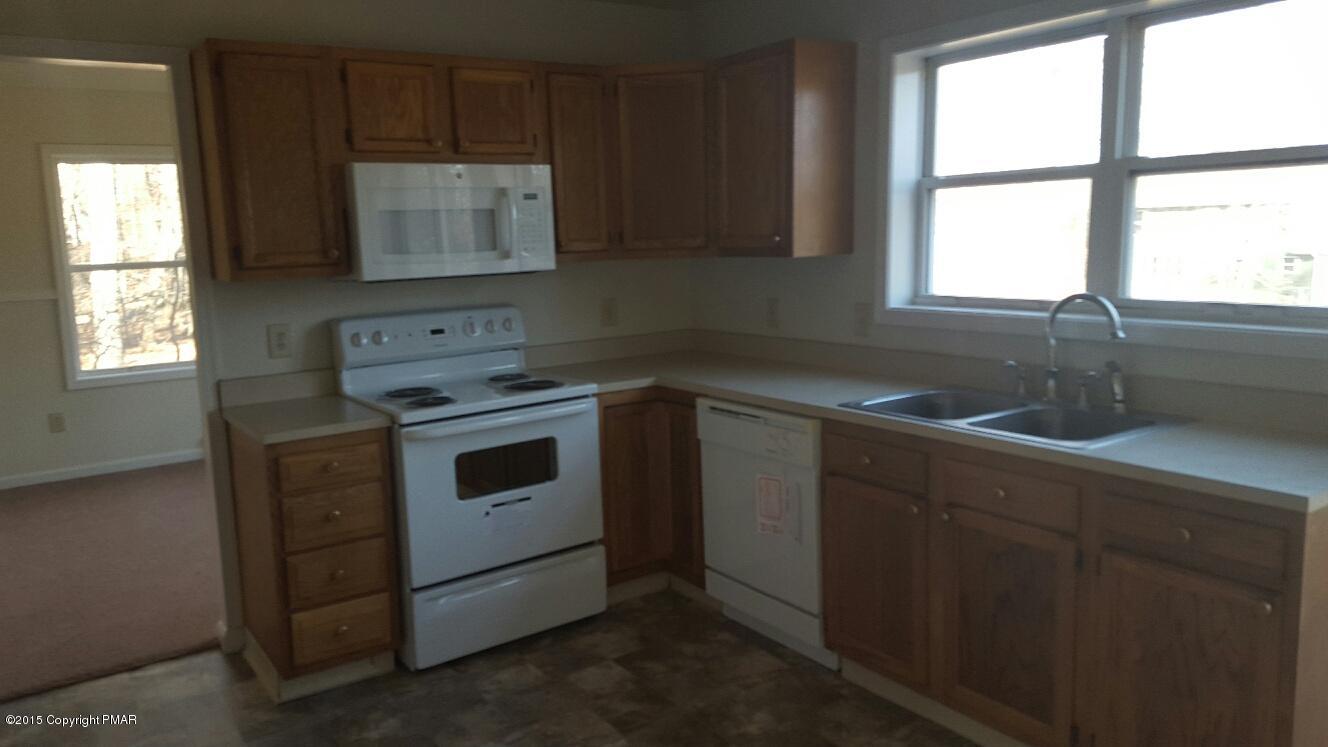 46 Dancing Ridge Road East Stroudsburg, PA 18302 - Photo 15 of 16 a kitchen with granite countertop white cabinets sink and window