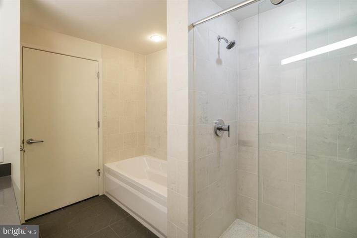 2101 Market Street, Unit 4205 Philadelphia, PA 19103 - Photo 4 of 31 a bathroom with a bathtub and a shower