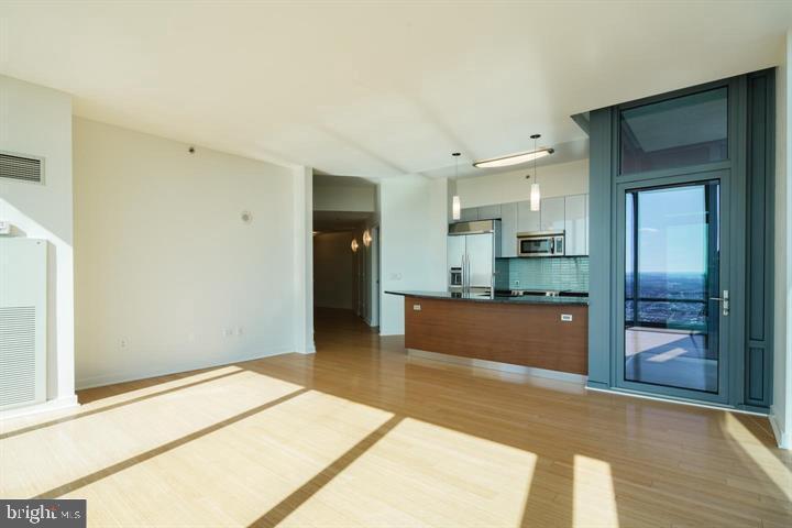 2101 Market Street, Unit 4205 Philadelphia, PA 19103 - Photo 10 of 31 a large kitchen with kitchen island granite countertop a refrigerator and a sink