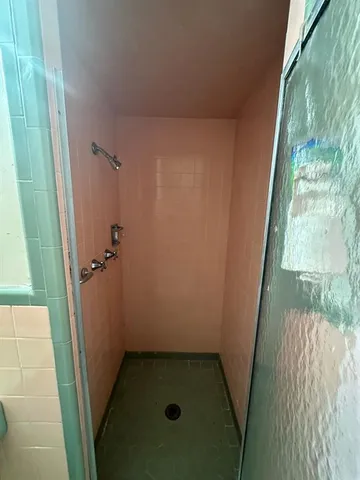 an empty room with wooden floor and closet