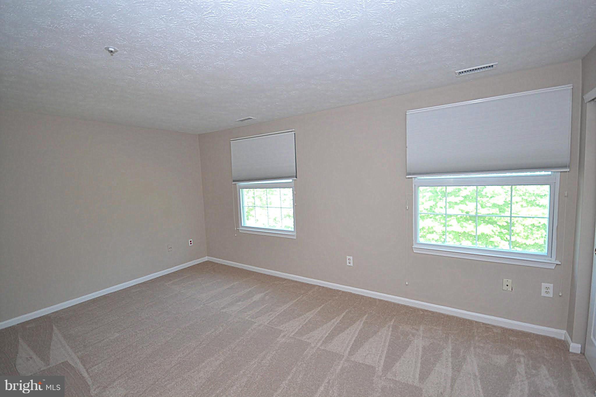 9044 Constant Course Columbia, MD 21046 - Photo 6 of 10 an empty room with windows