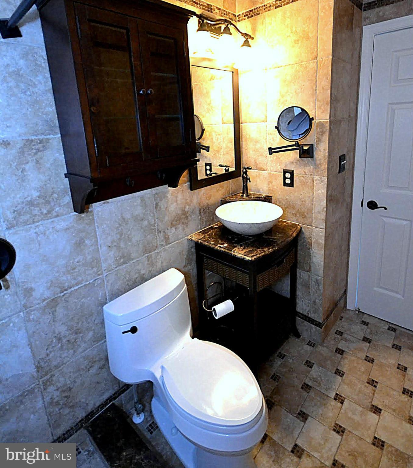 9044 Constant Course Columbia, MD 21046 - Photo 7 of 10 a bathroom with a toilet a sink and mirror