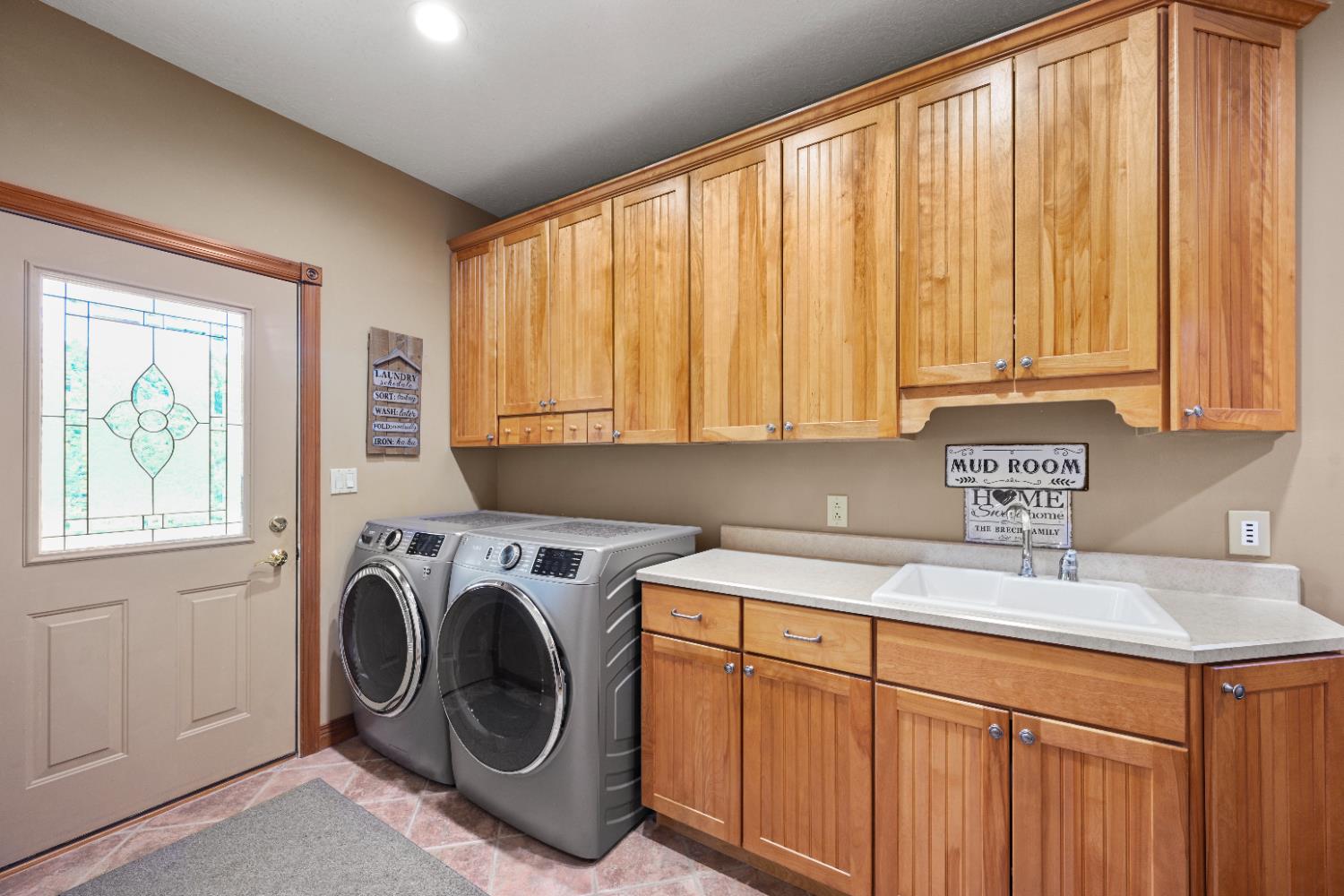 12656 Asche Road Sunman, IN 47041 - Photo 29 of 82 The main floor laundry/mudroom features more custom cabinets, 2 year old washer & dryer & deep sink.