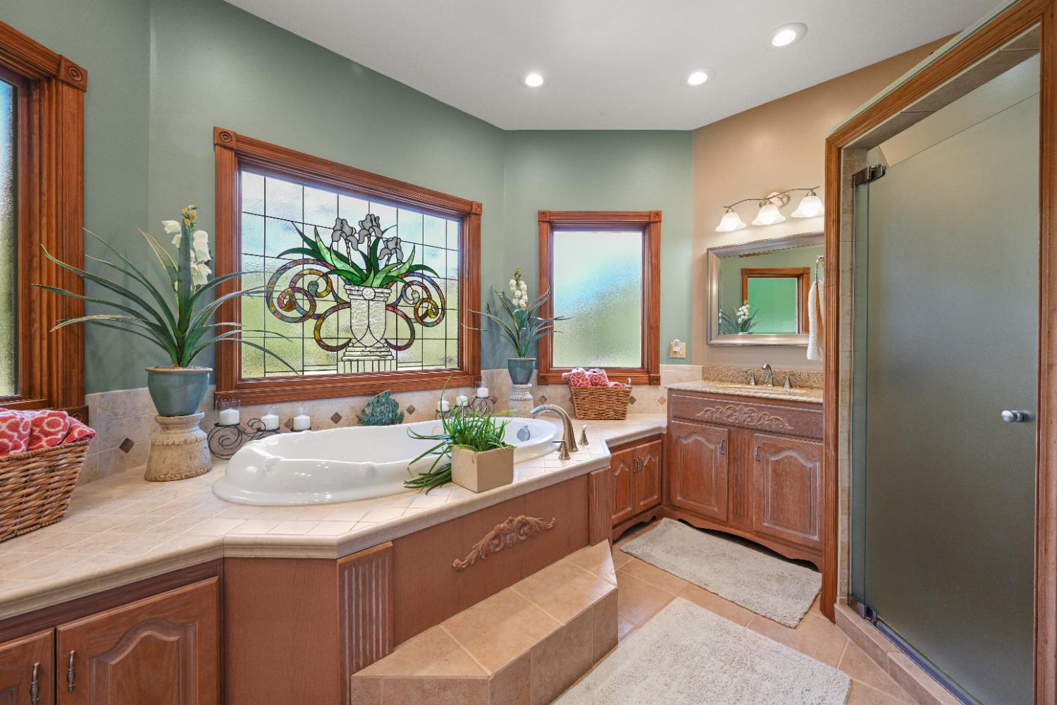 12656 Asche Road Sunman, IN 47041 - Photo 34 of 82 Master Bath jet tub enhanced by a stained glass window sits across the bath from a large walk-in shower