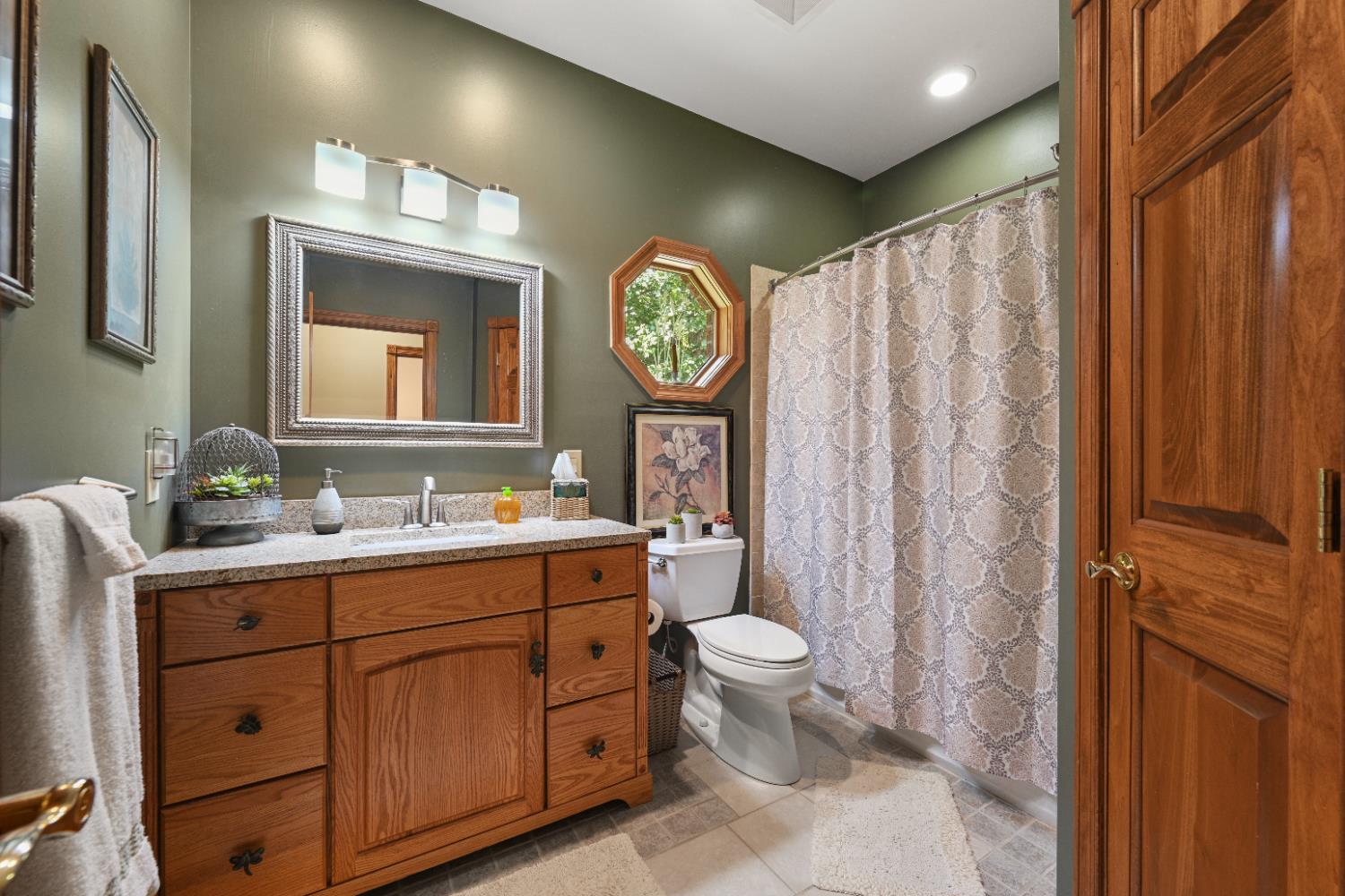 12656 Asche Road Sunman, IN 47041 - Photo 39 of 82 The hall bath features tile floors, a tub/shower with decorative tile walls and a linen closet.