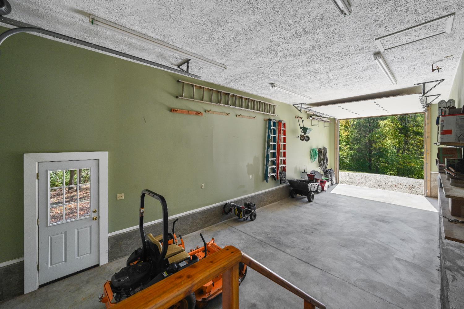 12656 Asche Road Sunman, IN 47041 - Photo 59 of 82 The entire rear of the outbuilding is a drive through RV garage, with a high door at one end and a standard door on the other. There's a second driveway that branches off the main driveway leading to the RV garage door.