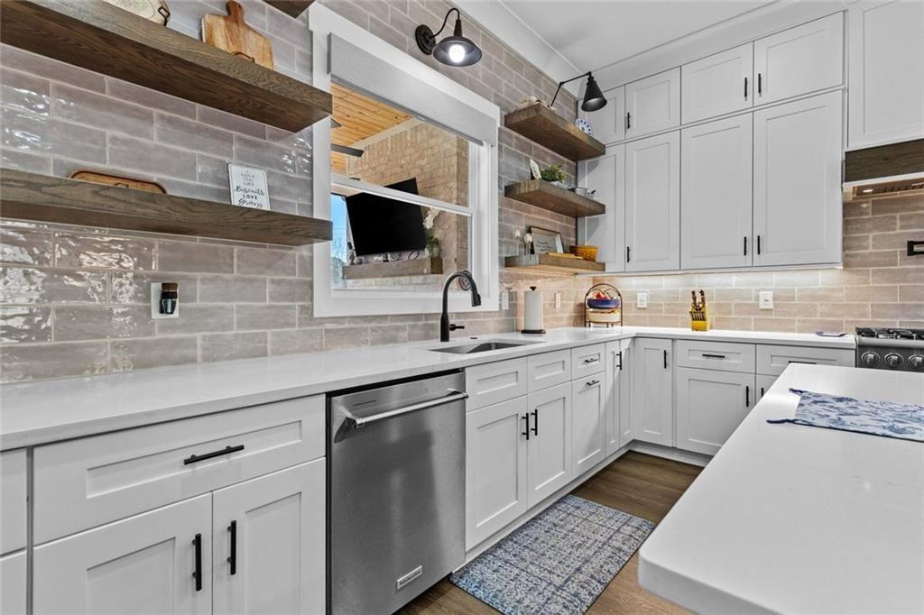 825 Arch Tanner Road Bethlehem, GA 30620 - Photo 18 of 58 a kitchen with cabinets a sink and appliances