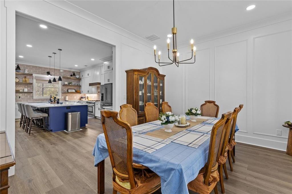 825 Arch Tanner Road Bethlehem, GA 30620 - Photo 21 of 58 a view of a dining room with furniture wooden floor and chandelier
