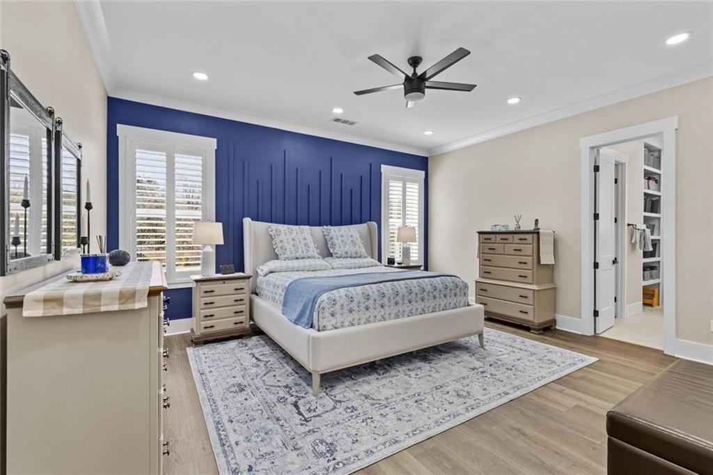 825 Arch Tanner Road Bethlehem, GA 30620 - Photo 24 of 58 a bedroom with a large bed a chandelier and dresser