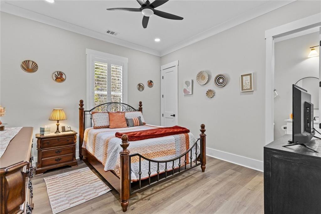 825 Arch Tanner Road Bethlehem, GA 30620 - Photo 38 of 58 a bedroom with a bed and a flat screen tv