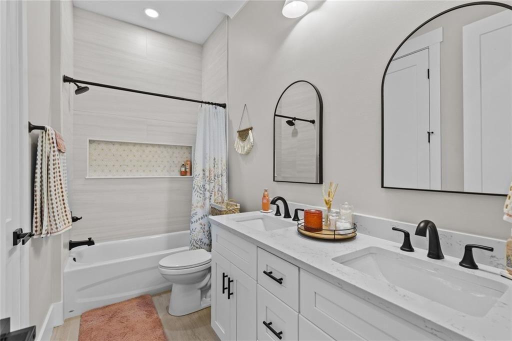 825 Arch Tanner Road Bethlehem, GA 30620 - Photo 40 of 58 a bathroom with a granite countertop sink a toilet and a mirror