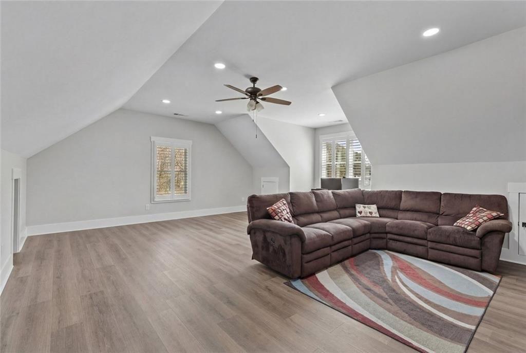 825 Arch Tanner Road Bethlehem, GA 30620 - Photo 41 of 58 a living room with couches and a ceiling fan with wooden floor