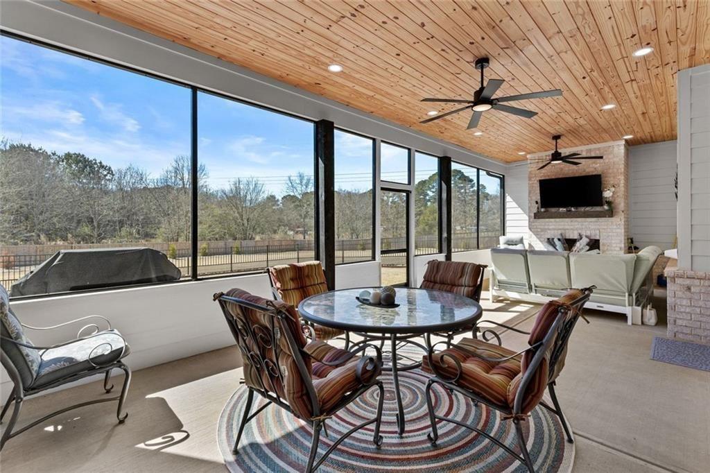 825 Arch Tanner Road Bethlehem, GA 30620 - Photo 44 of 58 a dining room with furniture a flat screen tv and a large window