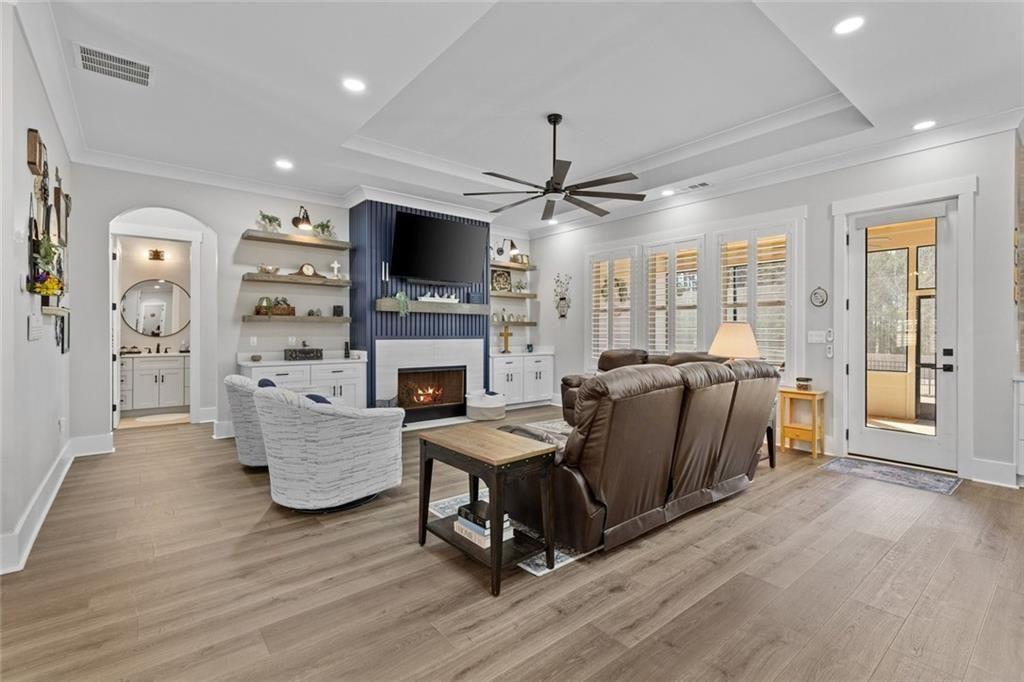 825 Arch Tanner Road Bethlehem, GA 30620 - Photo 9 of 58 a living room with furniture a flat screen tv and a fireplace