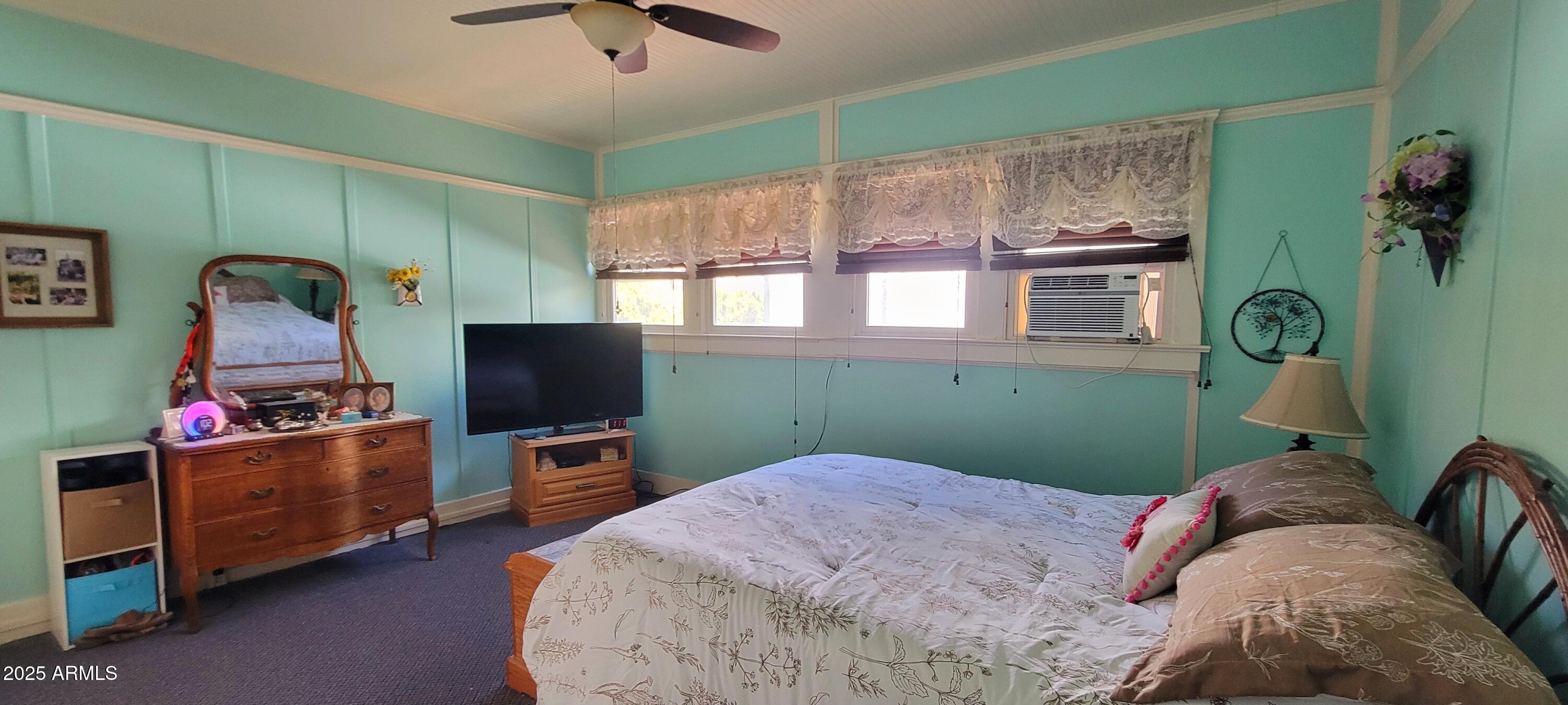 416 Tombstone Canyon Bisbee, AZ 85603 - Photo 11 of 42 a bedroom with furniture and a flat screen tv
