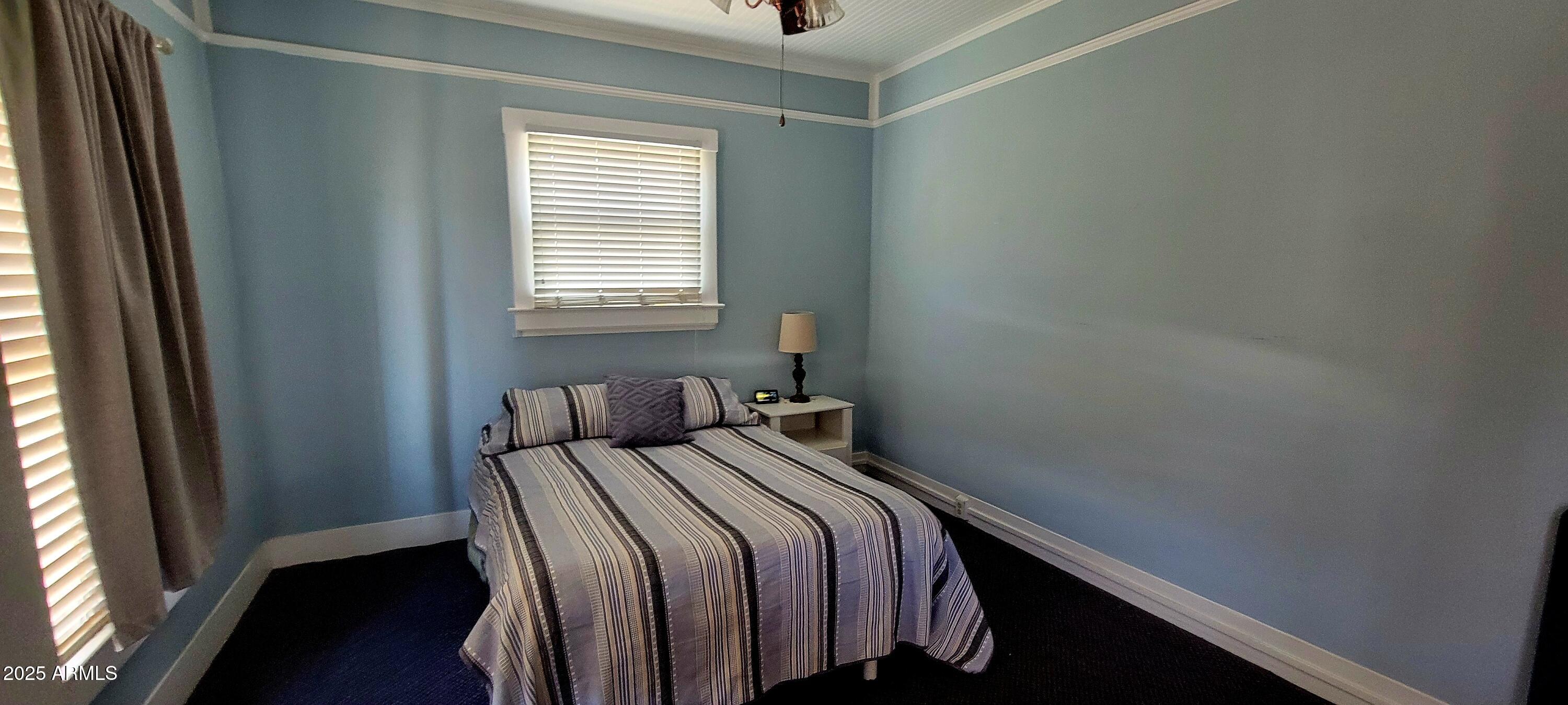 416 Tombstone Canyon Bisbee, AZ 85603 - Photo 14 of 42 a bedroom with a bed and a window