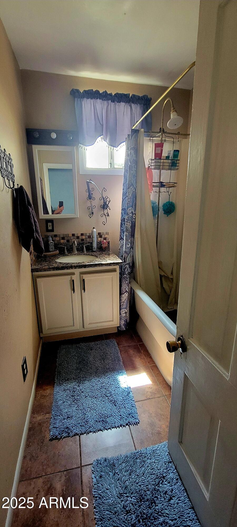 416 Tombstone Canyon Bisbee, AZ 85603 - Photo 21 of 42 a bathroom with a sink a mirror and a shower