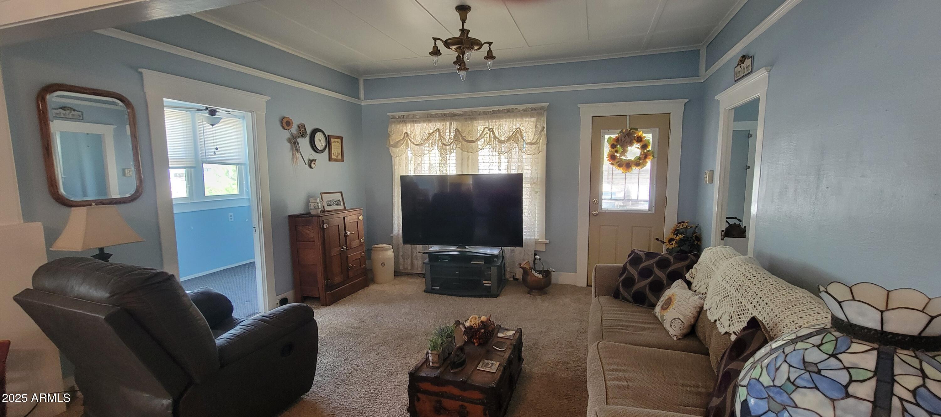 416 Tombstone Canyon Bisbee, AZ 85603 - Photo 3 of 42 a living room with furniture and a flat screen tv