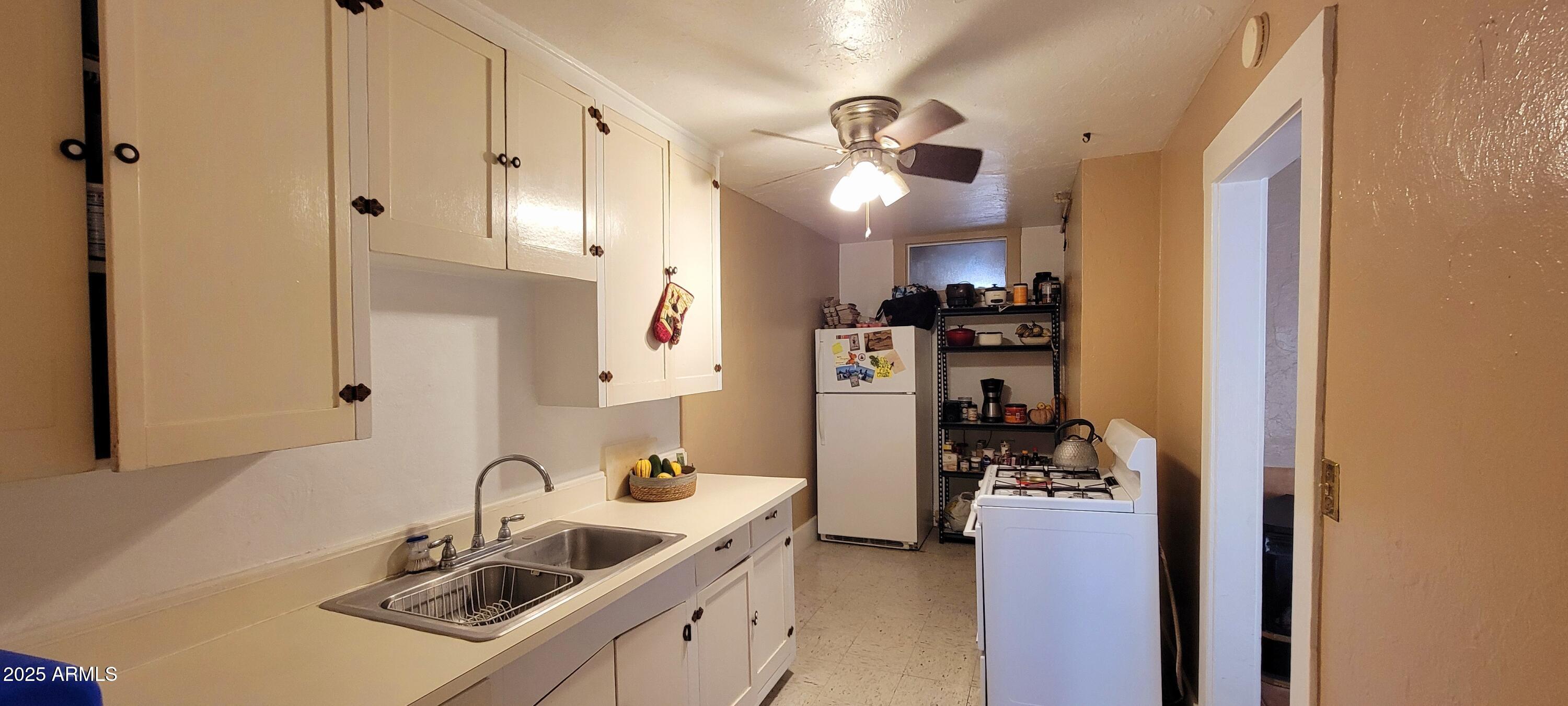 416 Tombstone Canyon Bisbee, AZ 85603 - Photo 31 of 42 a kitchen with stainless steel appliances kitchen island granite countertop a sink and cabinets
