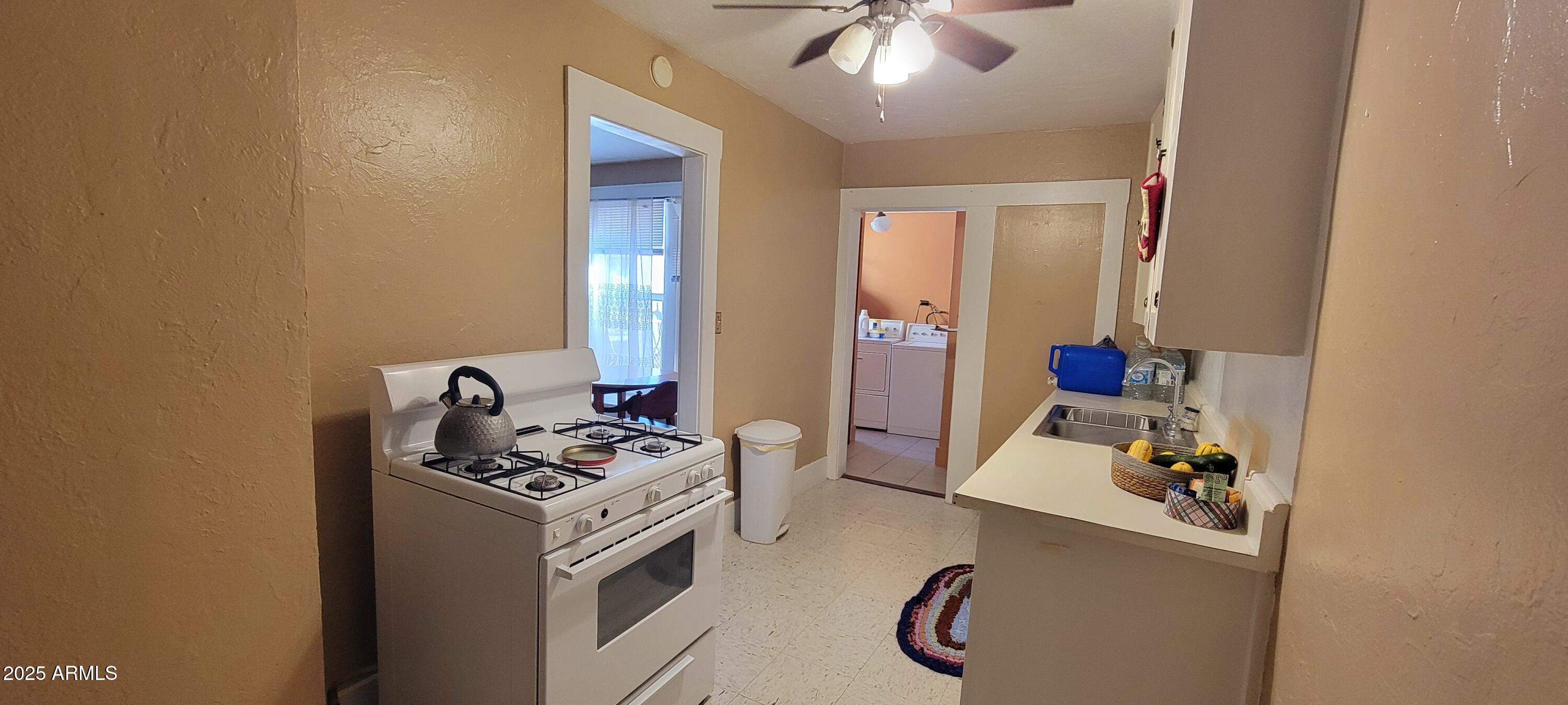 416 Tombstone Canyon Bisbee, AZ 85603 - Photo 33 of 42 a kitchen with stainless steel appliances a stove a sink and cabinets