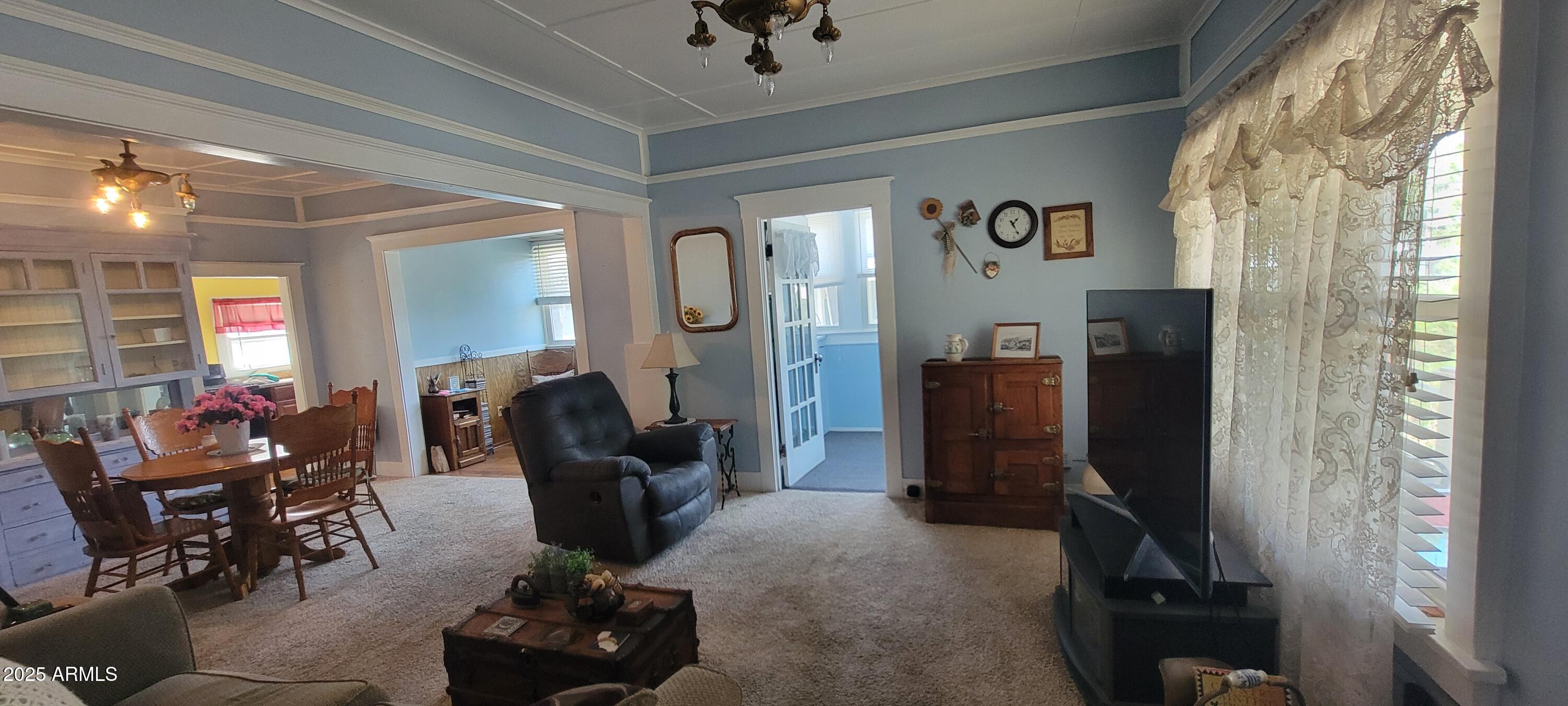 416 Tombstone Canyon Bisbee, AZ 85603 - Photo 4 of 42 a living room with furniture and a chandelier