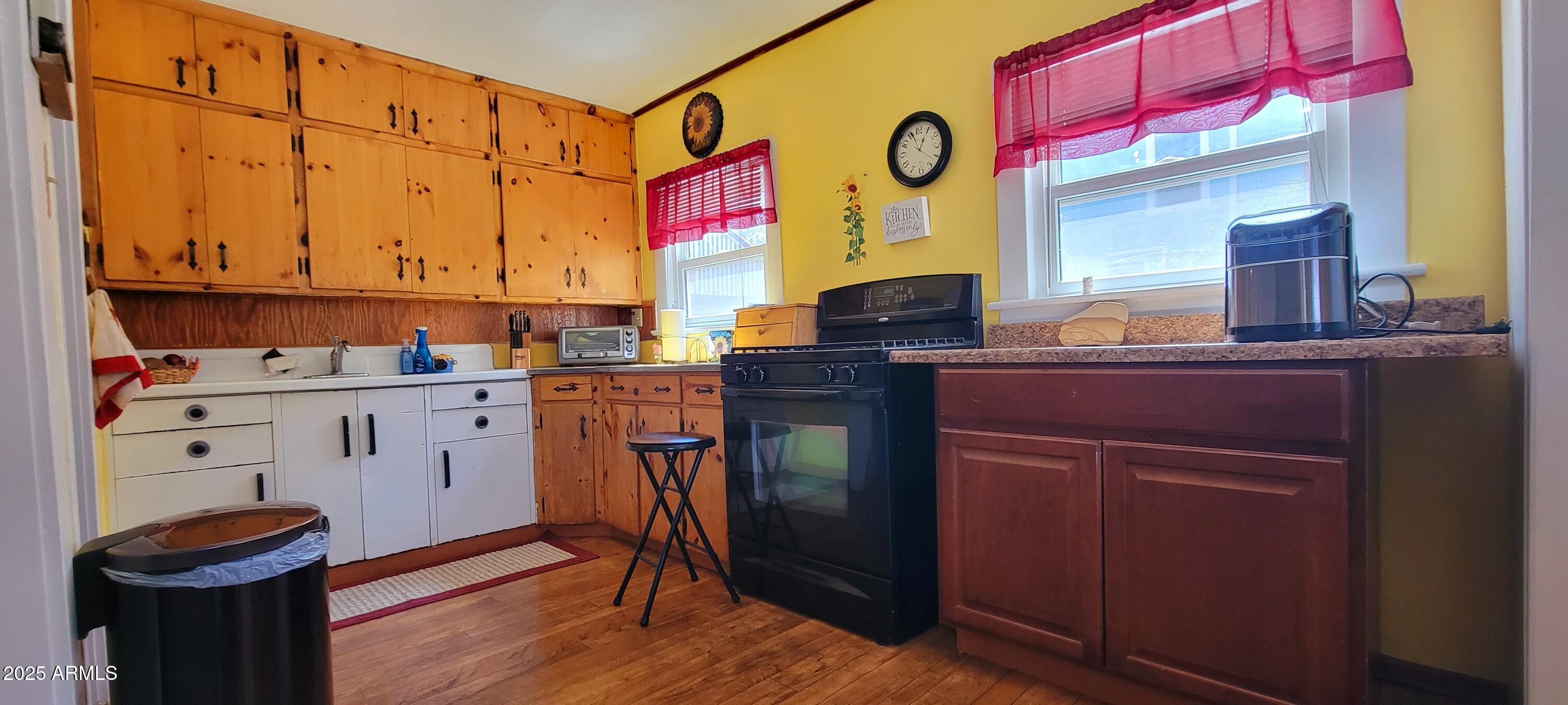 416 Tombstone Canyon Bisbee, AZ 85603 - Photo 9 of 42 a view of kitchen with stainless steel appliances granite countertop a stove a sink dishwasher and cabinets with wooden floor