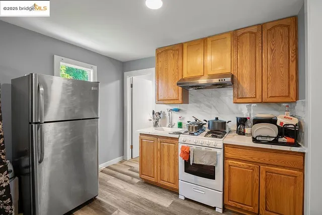 a kitchen with stainless steel appliances a refrigerator sink and cabinets