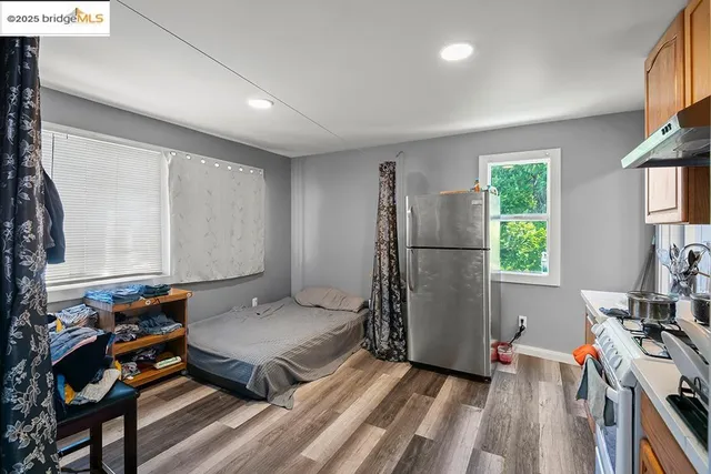 a living room with a bed furniture and a window