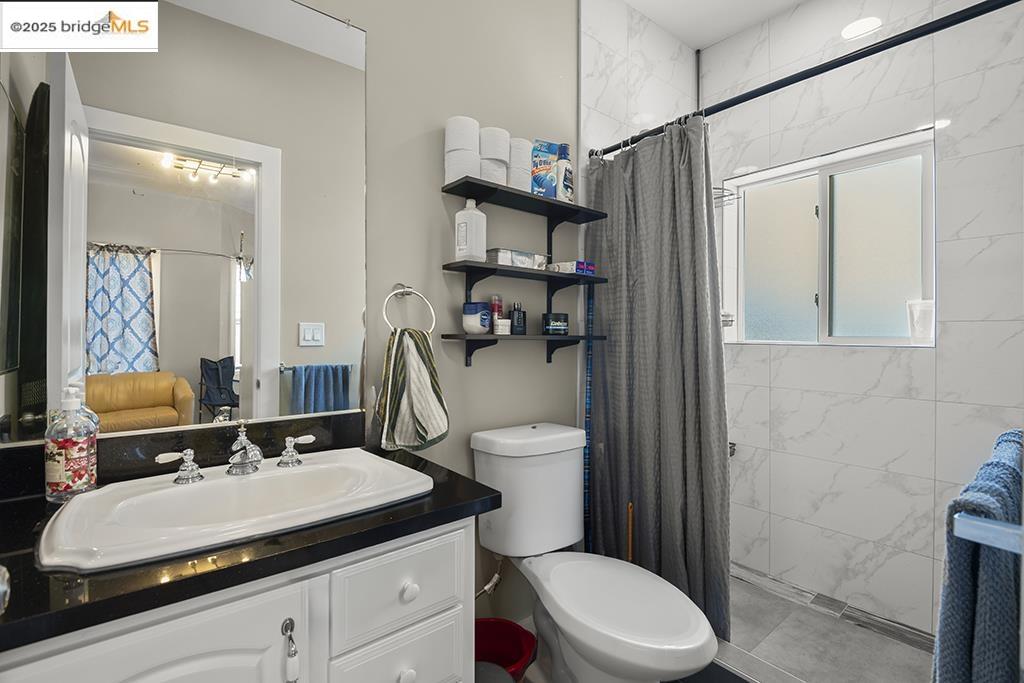 2004 27th Avenue Oakland, CA 94601 - Photo 5 of 14 a bathroom with a sink toilet vanity and shower