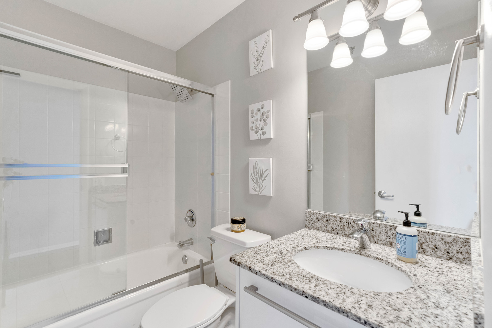 780 South Federal Street, Unit 1210 Chicago, IL 60605 - Photo 18 of 20 a bathroom with a granite countertop sink a toilet and shower