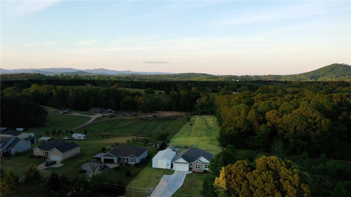 696 Mt Olivet Road Six Mile, SC 29682 - Photo 35 of 35 This elevated view captures a serene landscape with houses nestled among lush trees and distant mountains.