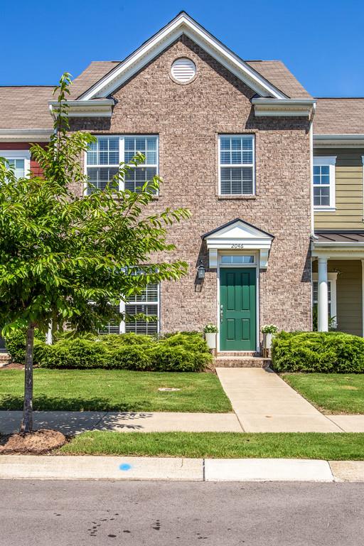 2046 Hemlock Drive Spring Hill, TN 37174 - Photo 1 of 28 a front view of a house with a yard and potted plants