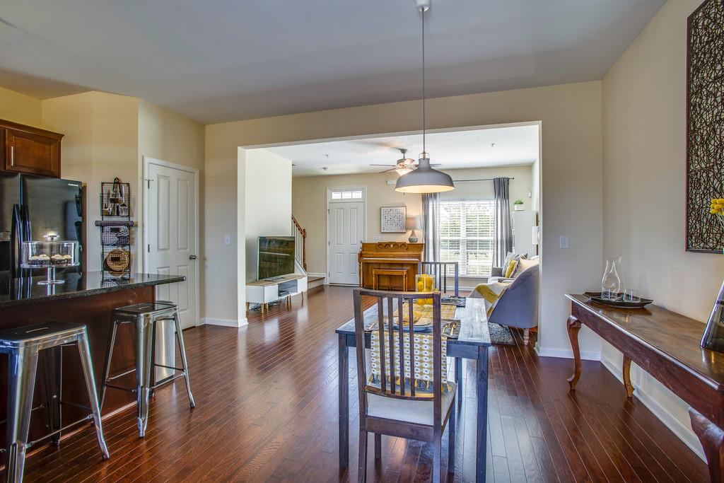 2046 Hemlock Drive Spring Hill, TN 37174 - Photo 11 of 28 a view of a dining room with furniture wooden floor and chandelier